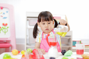 Wall Mural - young  girl pretend play food preparing at home