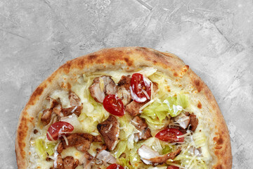 Wall Mural - Delicious pizza Caesar style with white sauce, chicken, parmesan, egg, cherry tomatoes and fresh lettuce at wooden background. Restaurant pizzeria menu with delicious taste pizza Caesar.