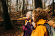 © Jordi Salas - Two senior female friends hiking together through the forest in autumn