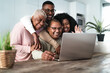 © Alessandro Biascioli - Happy Hispanic family having fun doing video call with parents using laptop at home