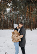 © Yuliia - Young couple walking in the park covered with snow. Winter walk