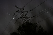 Metal Electricity Pylon During The Night On A Cloudy Sky Background