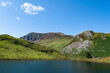 Beautiful mountain landscape, Snowdonia, Wales. Dramatic high angle shot of Llyn Dywarchen, a tranquil reservoir high in the Welsh mountains. Blue sky and copy space.