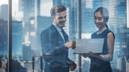 Poster - Portrait of Successful Corporate CEO and Investment Manager Talking, Using Laptop Computer while Standing in City Office. Two Successful Businesspeople Brainstorm on e-Commerce Marketing Project.