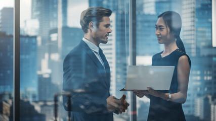 Poster - Portrait of Successful Corporate CEO and Finance Manager Talking, Using Laptop Computer while Standing in City Office. Stock Market Investors Negotiate e-Commerce Business Purchase.