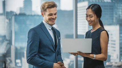 Poster - Portrait of Successful Corporate CEO and Investment Manager Talking, Using Laptop Computer while Standing in City Office. Two Successful Businesspeople Brainstorm on e-Commerce Marketing Project.
