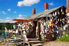 A Lobster Shack In Maine Is Decorated With Numerous Lobster Buoys And A Sign Advising Their Food Is Fresh Off The Boat