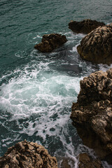 Sticker - Sea waves rolling and crashing on the rocks with a splash during the daytime