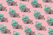 Creative Pattern Made With Glittering Silver Present Boxes With Green Bows On Pastel Background. Christmas Or Birthday Gift Concept. Holiday Theme. Minimal Style.