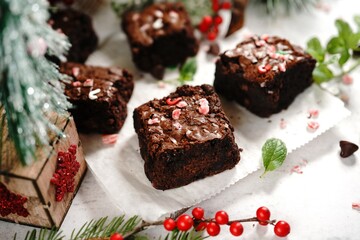 Sticker - Homemade Peppermint fudge brownies on xmas holiday background, selective focus