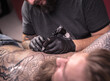 © Mr. Prof - Master of the art of tattooing creates a tattoo