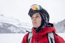 Portrait Female Skier With Goggles Looking Up