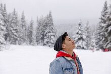 Portrait Serene Handsome Teenage Boy In Snowy Winter Woods