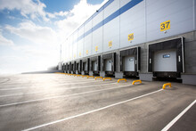 Wall Of A Huge Distribution Warehouse With Row Of Loading Gates