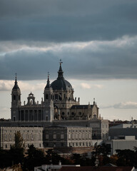 Sticker - Mesmerizing scene of the Almudena Cathedral in Madrid, Spain with a gray hazy cloudy sky