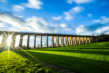 The Ouse Valley Viaduct In The Late Afternoon Sun With Clouds Streaming Overhead
