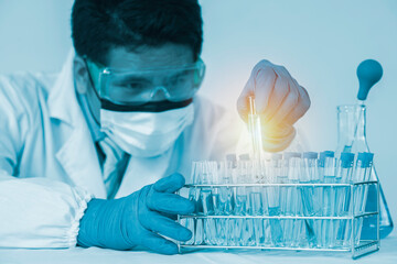 Researchers scientist working analysis with blue liquid test tube in the laboratory, chemistry science or medical biology experiment technology