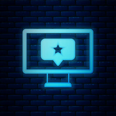 Sticker - Glowing neon Monitor with star icon isolated on brick wall background. Favorite, best rating, award symbol. Vector