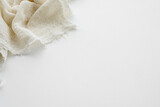 Fototapeta Boho - Top view of a white table and a cotton eco-friendly napkin.  Kitchen background.