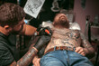 © Mr. Prof - Tattooist doing tattoo picture in tattoo studio