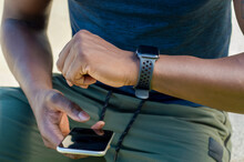 Close Up Of Man Using Smart Phone And Smart Watch