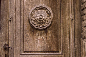 Sticker - Closeup shot of an old wooden door with flower ornaments