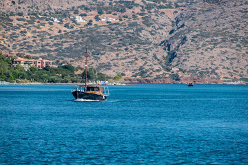 Sticker - Peaceful scene with a boat floating in the blue sea, Crete island, Greece