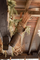 Canvas Print - Vertical shot of rustic style decor with dry twigs, plants, and wooden elements