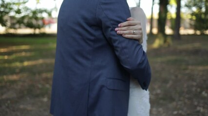 Poster - An HD video of an unrecognizable wedding couple in a hug in a forest