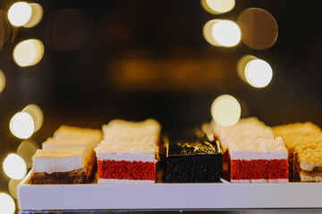 Poster - View of delicious cakes on the plate at the wedding and bokeh lights