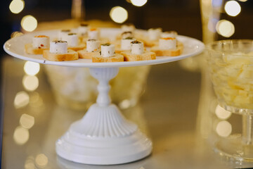 Poster - View of delicious snacks on the plate at the wedding and bokeh lights