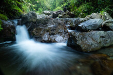Natural View Of Water Flowing Downstream On A Rocky River With Long Exposure