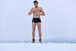 © Volodymyr - Naked sexy man hardening in cold snow. Winter fun, tempering procedures. Guy snow showers for the hardening of the body. Winter healthy lifestyle.