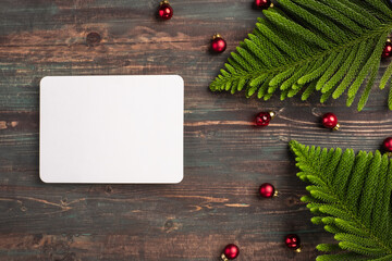 Aufkleber - Christmas greeting card on pine leaf with bauble decoration on wooden table