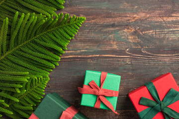 Aufkleber - Christmas colorful gift box with pine leaf and decoration ornament on wooden table