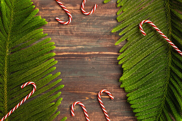 Aufkleber - Christmas pine branch and red candy cane on wooden table background