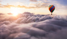 Dramatic Mountain Landscape Covered In Clouds And Hot Air Balloon Flying. 3d Rendering Adventure Dream Concept Artwork. Aerial Image From British Columbia, Canada. Sunset Or Sunrise Sky