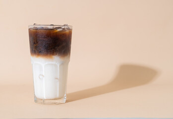 Wall Mural - iced coffee with milk layer in glass