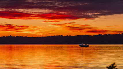 Wall Mural - Old boat on the sea on the sunset