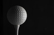 low key golf ball tee black background