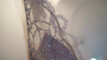 Sticker - A closeup of a hanging luxurious wedding dress