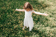 © Татьяна Волкова - Little girl in white dress, arms outstretched, stands in middle of blooming meadow. Life insurance. Carefree childhood. Summer days. Beauty of nature. Walks and adventures