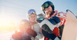 Banner winter sport travel. Happy young couple man and woman snowboarders on background of ski resort sun day