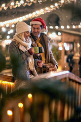 Wall Mural - Couple outdoor in winter drinking hot tea and enjoy at romantic Christmas night