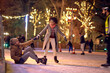 © luckybusiness - Lovely multiethnic couple enjoying ice skating; Christmas joy concept