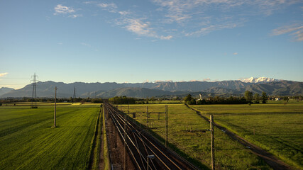 Poster - Long exposure shot of a field with a railway, and hills in the background