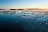Fototapeta Niebo - Winter short day in Scandinavia, Floating ice on lake Malaren, Vasteras, Sweden