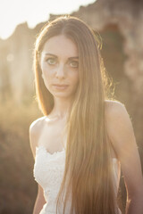 Canvas Print - Vertical shot of a young Caucasian female in a dress in the field