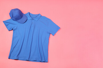 Wall Mural - Blank t-shirt and cap on pink background