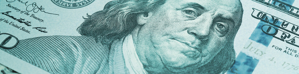 american paper money. a $100 bill with focus on eyes of benjamin franklin. us banknotes close-up. bu